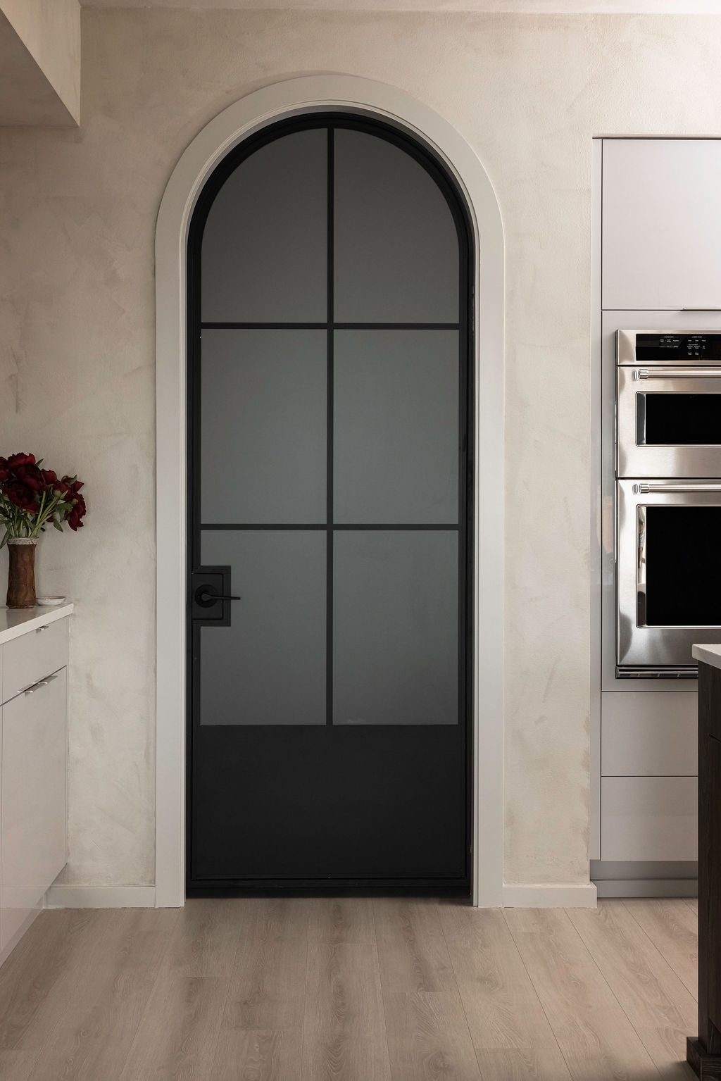 The Timara House detail with arched black door pantry