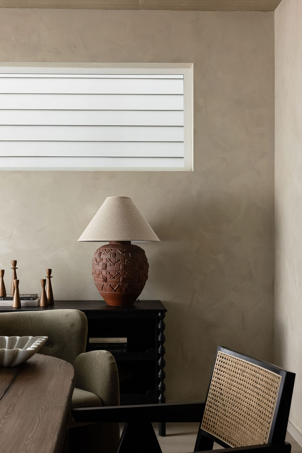 The Timara House detail with terracotta lamp on black sideboard